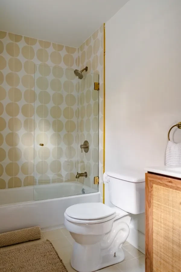Bathroom with gold circle tile tub surround