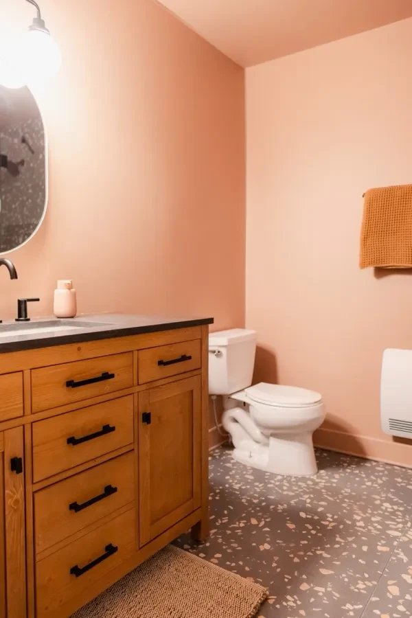 Bathroom with peach walls and terrazzo floor