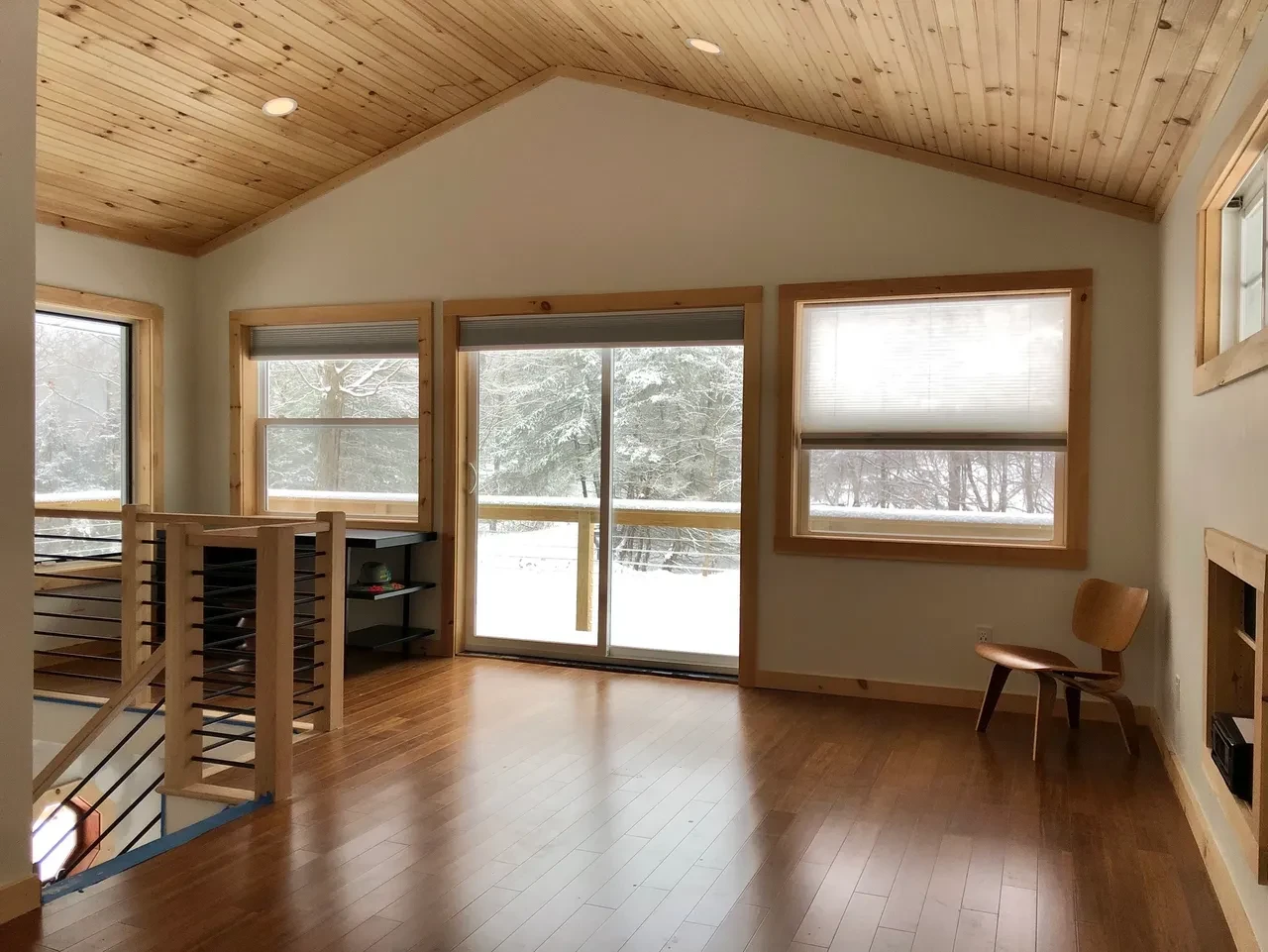 Finished open concept living room with wood ceiling and sliding doors